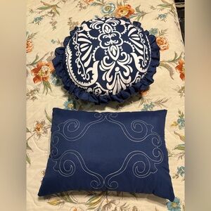 Two blue and white throw pillows